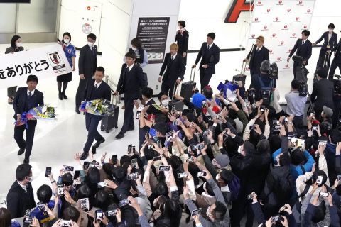Supporters welcome home the Japanese national soccer team, including head coach Hajime Moriyasu, left, from the World Cup in Qatar at Narita International Airport in Narita, east of Tokyo, Wednesday, Dec. 7, 2022. (AP Photo/Shuji Kajiyama)