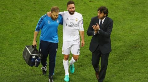 MILAN, ITALY - MAY 28:  Dani Carvajal of Real Madrid is is lead of the pitch as he substituted after getting injured during the UEFA Champions League Final match between Real Madrid and Club Atletico de Madrid at Stadio Giuseppe Meazza on May 28, 2016 in Milan, Italy.  (Photo by Clive Mason/Getty Images)