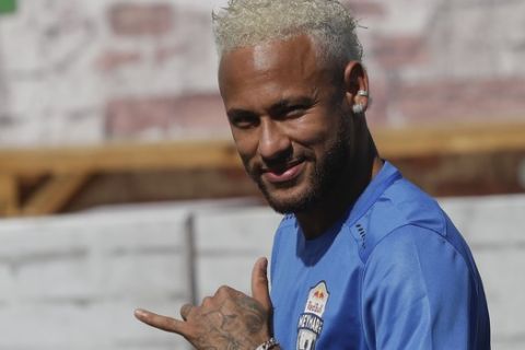 Brazilian soccer player Neymar flashes a "hang loose" gesture to fans during the Neymar Jr's Five youth soccer tournament in Praia Grande, Brazil, Saturday, July 13, 2019. (AP Photo/Andre Penner)