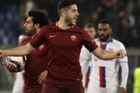 Roma's Kostas Manolas, right, celebrates his sides second goal during the Europa League round of 16 second leg soccer match between Roma and Lyon, in Rome's Olympic stadium, Thursday, March 16, 2017. (AP Photo/Andrew Medichini)
