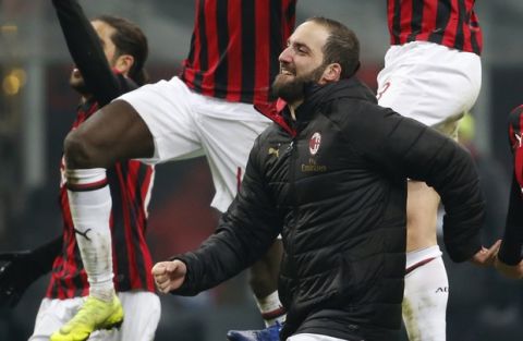 AC Milan's Gonzalo Higuain and his teammates celebrate at the end of a Serie A soccer match between AC Milan and Spal, at the San Siro stadium, Saturday, Dec. 29, 2018. Milan won 2-1. (AP Photo/Antonio Calanni)