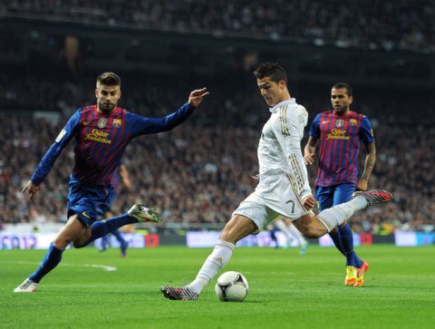 MADRID, SPAIN - JANUARY 18:  Cristiano Ronaldo of Real Madrid strikes to score his side's opening goal during the Copa del Rey quarter final match between Real Madrid and Barcelona at Estadio Santiago Bernabeu on January 18, 2012 in Madrid, Spain.  (Photo by Jasper Juinen/Getty Images) *** BESTPIX ***