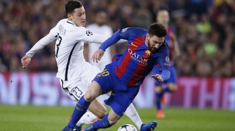 Barcelona's Lionel Messi, right, is tackled by PSG's Julian Draxler during the Champion's League round of 16, second leg soccer match between FC Barcelona and Paris Saint Germain at the Camp Nou stadium in Barcelona, Spain, Wednesday March 8, 2017. (AP Photo/Manu Fernandez)