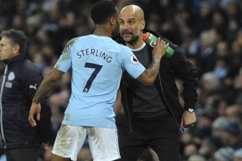 Manchester City's Raheem Sterling, left, and Manchester City manager Josep Guardiola during the English Premier League soccer match between Manchester City and Leicester City at the Etihad Stadium in Manchester, England, Saturday, Feb. 10, 2018. (AP Photo/Rui Vieira)
