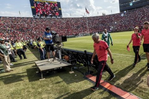 Manchester United manager Jose Mourinho walks off the pitch after the first half of an International Champions Cup tournament soccer match against Liverpool at Michigan Stadium, Saturday, July 28, 2018, in Ann Arbor, Mich. (AP Photo/Tony Ding)