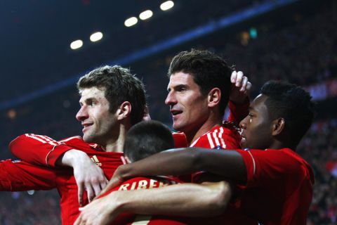 MUNICH, GERMANY - MARCH 13:  Mario Gomez (2R) of Muenchen celebrates his team's fourth goal with team mates Franck Ribery (front, hidden), Thomas Mueller (L) and David Alaba (R) during the UEFA Champions League Round of 16 second leg match between FC Bayern Muenchen and FC Basel at Allianz Arena on March 13, 2012 in Munich, Germany.  (Photo by Alex Grimm/Bongarts/Getty Images)