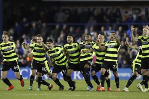 Huddersfield Town's players celebrate winning on penalty's after the League Championship, second leg soccer match against Sheffield at Hillsborough, Sheffield, England, Wednesday, May 17, 2017. Huddersfield is one victory away from a place in Englands top division for the first time in 45 years after advancing to the second-tier League Championship playoff final on Wednesday. (Martin Rickett/PA via AP)