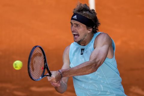 Alexander Zverev of Germany returns the ball against Italy's Lorenzo Musetti during their match at the Mutua Madrid Open tennis tournament in Madrid, Spain, Thursday, May 5, 2022. (AP Photo/Manu Fernandez)
