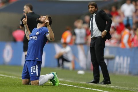Chelsea's Olivier Giroud celebrates after scoring his side opening goal during the English FA Cup semifinal soccer match between Chelsea and Southampton at the Wembley stadium in London, Sunday, April 22, 2018. At right is Chelsea's team manager Antonio Conte. (AP Photo/Frank Augstein)