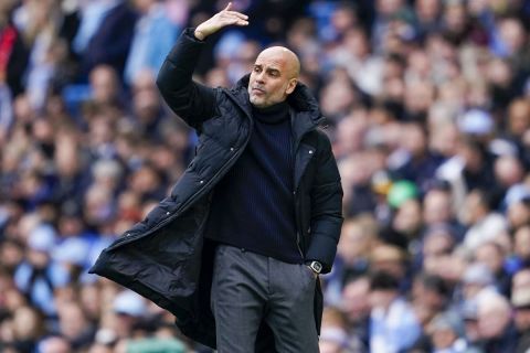 Manchester City's head coach Pep Guardiola gestures during the English Premier League soccer match between Manchester City and Arsenal at the Etihad stadium in Manchester, England, Sunday, March 31, 2024. (AP Photo/Dave Thompson)