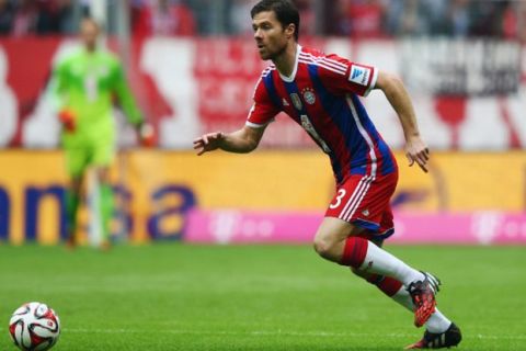 MUNICH, GERMANY - SEPTEMBER 13:  Xabi Alonso of Muenchen controles the ball during the Bundesliga match between FC Bayern Muenchen and VfB Stuttgart at Allianz Arena on September 13, 2014 in Munich, Germany.  (Photo by Alex Grimm/Bongarts/Getty Images) 