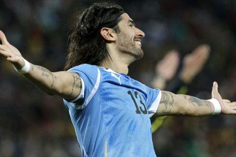 Uruguay's Sebastian Abreu celebrates after scoring the decisive goal on a shootout penalty during the World Cup quarterfinal soccer match between Uruguay and Ghana at Soccer City in Johannesburg, South Africa, Friday, July 2, 2010. Uruguay reached the World Cup semifinals for the first time since 1970, beating Ghana 4-2 on penalties after a 1-1 draw Friday. (AP Photo/Bernat Armangue)