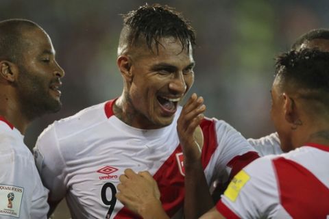 Peru's Jose Paolo Guerrero , center, celebrates after scoring against Venezuela with his teammates Alberto Rodriguez, left, Andre Carrillo and Christian Cueva, right, during a 2018 World Cup qualifying soccer match in Maturin, Venezuela, Thursday, March 23, 2017. The game ended in a 2-2 draw. (AP Photo/Fernando Llano)