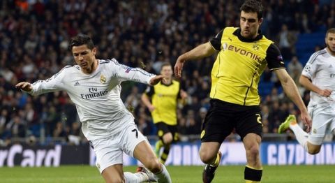 Real Madrid's Portuguese forward Cristiano Ronaldo  (L)  vies with  Dortmund's Greek defender Sokratis during the UEFA Champions League quarterfinal first leg football match Real Madrid FC vs Borussia Dortmund at the Santiago Bernabeu stadium in Madrid on April 2, 2014.   AFP PHOTO/ GERARD JULIEN        (Photo credit should read GERARD JULIEN/AFP/Getty Images)
