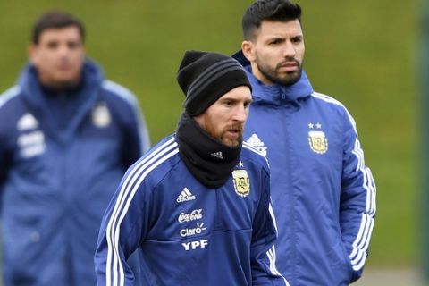 Argentina's Sergio Aguero, right, and Lionel Messi attends a training session at the City Football Academy, in Manchester, England, Tuesday March 20, 2018. Argentina will play Italy in an international friendly on Friday. (Dave Howarth//PA via AP)