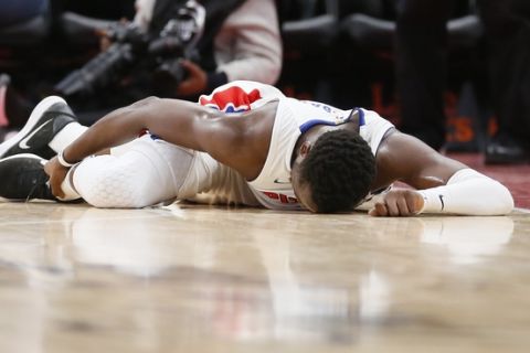 Detroit Pistons guard Reggie Jackson (1) lays on the court after injuring his right ankle during the second half of an NBA basketball game against the Indiana Pacers Tuesday, Dec. 26, 2017, in Detroit. The Pistons defeated the Pacers 107-83. (AP Photo/Duane Burleson)