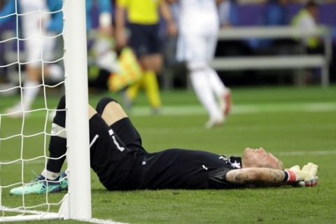 FILE - In this May 26, 2018, file photo, Liverpool goalkeeper Loris Karius reacts after Real Madrid's Gareth Bale scored during the Champions League final soccer match at the Olimpiyskiy Stadium in Kiev, Ukraine. Doctors based in Boston have concluded Karius sustained a concussion during last months Champions League final that would have affected his performance. (AP Photo/Sergei Grits, File)