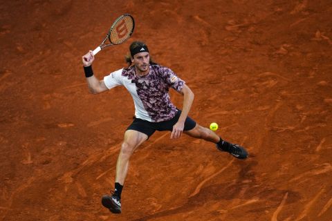 Stefanos Tsitsipas of Greece returns the ball against Dominic Thiem of Austria during their match at the Madrid Open tennis tournament in Madrid, Spain, Saturday, April 29, 2023. (AP Photo/Manu Fernandez)