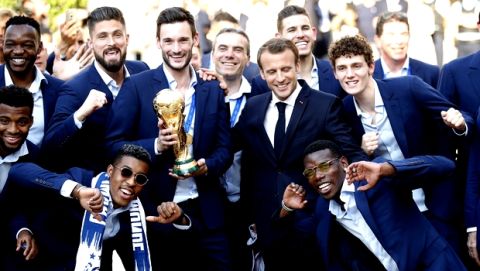 French President Emmanuel Macron, third right, poses with the French soccer players at the presidential Elysee Palace after the parade down the Champs-Elysees, where tens of thousands thronged after the team's 4-2 victory over Croatia at the Monday, July 16, 2018 in Paris. (AP Photo/Francois Mori)