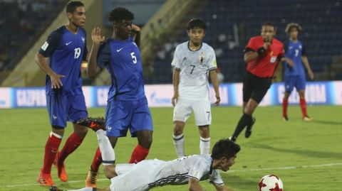 Japan's Taisei Miyashiro 11, falls as France's William Bianda,5, fouls him in the box before a successful penalty goal during the FIFA U-17 World Cup match in Gauhati, India, Wednesday, Oct.11, 2017. (AP Photo/Anupam Nath)