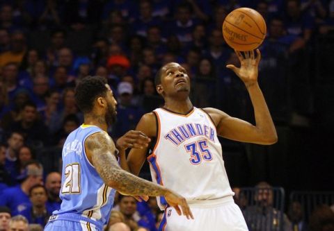 OKLAHOMA CITY, OK - APRIL 20: Kevin Durant #35 of the Oklahoma City Thunder looks to hold on to a pass \\against Wilson Chandler #21 of the Denver Nuggets in Game Two of the Western Conference Quarterfinals in the 2011 NBA Playoffs on April 20, 2011 at the Ford Center in Oklahoma City, Oklahoma. NOTE TO USER: User expressly acknowledges and agrees that, by downloading and or using this photograph, User is consenting to the terms and conditions of the Getty Images License Agreement. (Photo by Dilip Vishwanat/Getty Images)