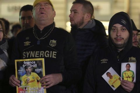 CAPTION CORRECTS THE YEAR Supporters gather to pay tribute to Argentinian soccer player Emiliano Sala, in Nantes, western France, Tuesday, Jan. 22, 2019. The search for the missing plane taking Argentine soccer player Emiliano Sala to his new team in Wales was called off for the night on Tuesday with authorities not expecting to find any survivors in the English Channel. (AP Photo/David Vincent)