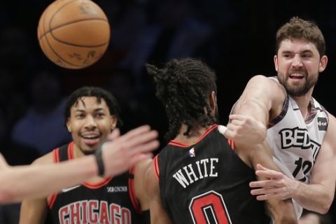 Brooklyn Nets' Joe Harris, right, passes around Chicago Bulls defenders during the first half of an NBA basketball game at the Barclays Center, Sunday, March 8, 2020, in New York. (AP Photo/Seth Wenig)