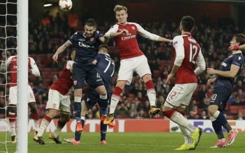 Arsenal's Rob Holding, center, and Red Star's Damien Le Tallec go for a header during a Group H Europa League soccer match between Arsenal London and Red Star Belgrade at the Emirates stadium in London, Britain, Thursday, Nov. 2, 2017. (AP Photo/Tim Ireland)