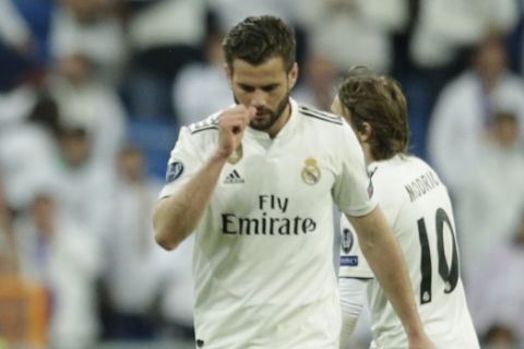 German referee Felix Brych shows the yellow card to Real defender Nacho Fernandez during the Champions League round of 16 second leg soccer match between Real Madrid and Ajax at the Santiago Bernabeu stadium in Madrid, Tuesday, March 5, 2019. (AP Photo/Bernat Armangue)