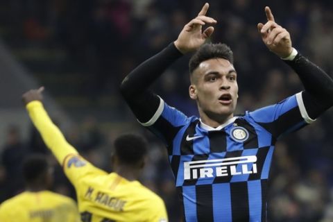 Inter Milan's Lautaro Martinez, right, reacts after a missed scoring opportunity during the Champions League, group F soccer match between Inter Milan and F.C. Barcelona, at the San Siro stadium in Milan, Italy, Tuesday, Dec. 10, 2019. (AP Photo/Luca Bruno)