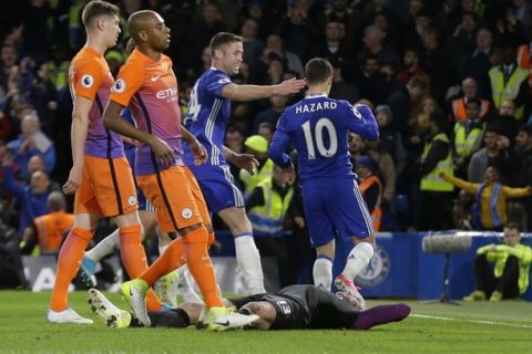 Manchester City goalkeeper Willy Caballero, on the ground, reacts after Chelsea's Eden Hazard, right, scored their second goal during the English Premier League soccer match between Chelsea and Manchester City at the Stamford Bridge stadium in London, Wednesday, April 5, 2017. (AP Photo/Alastair Grant)