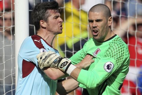 Burnley's Joey Barton, left, talks with Middlesbrough goalkeeper Victor Valdes in the goalmouth during their English Premier League soccer match at the Riverside Stadium in Middlesbrough, England, Saturday April 8, 2017. (Richard Sellers/PA via AP)