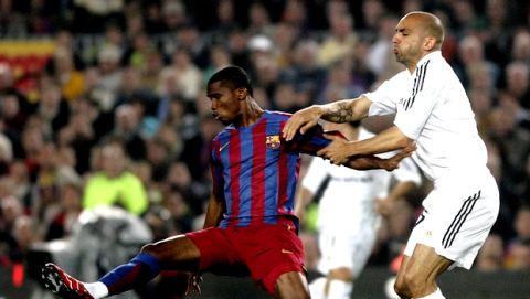 FC Barcelona player Samuel Eto'o, from Cameroon, left,  duels for the ball with Real Madrid player Raul Bravo, from Spain, during their Spanish League soccer match at the Camp Nou stadium in Barcelona, Spain, Saturday, April 1, 2006. (AP Photo/Manu Fernandez)