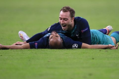 Tottenham's Christian Eriksen celebrates with teammate Lucas Moura, left, at the end of the Champions League semifinal second leg soccer match between Ajax and Tottenham Hotspur at the Johan Cruyff ArenA in Amsterdam, Netherlands, Wednesday, May 8, 2019. (AP Photo/Peter Dejong)
