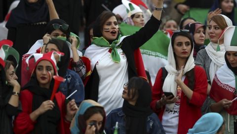 Iranian nurse Zahra Pashaei, center, cheers during an Iran and Cambodia 2022 World Cup qualifier soccer match at the Azadi (Freedom) Stadium, in Tehran, Iran, Thursday, Oct. 10, 2019 Iranian women were freely allowed into the stadium for the first time in decades. The decision follows the death of a young woman who set herself on fire after hearing she could face prison time for sneaking into an Iranian soccer match disguised as a man. (AP Photo/Vahid Salemi)