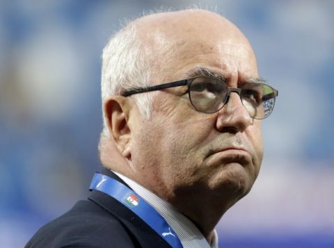 FILE - In this Tuesday, Sept. 5, 2017 file photo, President of the Italian Soccer Federation Carlo Tavecchio walks on the pitch prior to the World Cup Group G qualifying soccer match between Italy and Israel at the Mapei Stadium in Reggio Emilia, Italy. The refusal of Italian football federation president Carlo Tavecchio to resign is causing outrage. Damiano Tommasi, president of the Italian players association, abandoned a summit called Wednesday, Nov. 15, 2017 to assess the failed World Cup qualification once he understood that Tavecchio would not step down. (AP Photo/Luca Bruno, File)