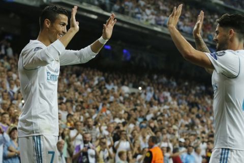 Real Madrid's Cristiano Ronaldo, left, celebrates scoring with teammate Isco during a Champions League group H soccer match between Real Madrid and Apoel Nicosia at the Santiago Bernabeu stadium in Madrid, Spain, Wednesday, Sept. 13, 2017. (AP Photo/Paul White)