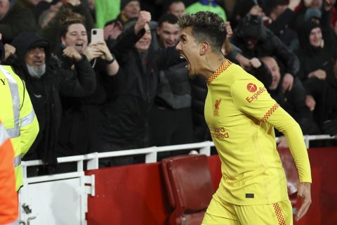 Liverpool's Roberto Firmino celebrates after scoring his team's second goal during the English Premier League soccer match between Arsenal and Liverpool at Emirates Stadium in London, Wednesday, March 16, 2022. (AP Photo/Ian Walton)