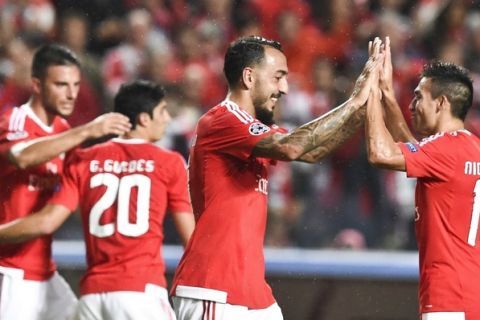 Benfica's Greek forward Konstantinos Mitroglou (C) celebrates a goal with teammate Argentinian midfielder Nico Gaitan (R) during the UEFA Champions League football match SL Benfica vs FC Astana at the Luz stadium in Lisbon on September 15, 2015. AFP PHOTO / FRANCISCO LEONG        (Photo credit should read FRANCISCO LEONG/AFP/Getty Images)