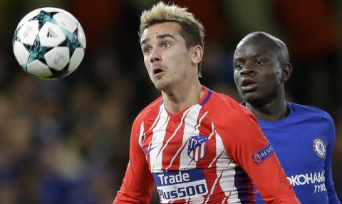 Chelsea's N'golo Kante, right, competes for the ball with Atletico's Antoine Griezmann during the Champions League Group C soccer match between Chelsea and Atletico Madrid at Stamford Bridge stadium in London Tuesday, Dec. 5, 2017. (AP Photo/Alastair Grant)