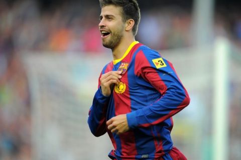 Barcelona's defender Gerard Pique celebrates after scoring a goal during the Spanish League football match between FC Barcelona and RCD Espanyol on May 8, 2011 at Camp Nou stadium in Barcelona. AFP PHOTO/ LLUIS GENE (Photo credit should read LLUIS GENE/AFP/Getty Images)