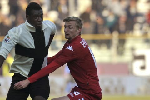 Parma's Afriyie Acquah of Ghana, left, vies for the ball with Cagliari's Sebastian Eriksson of Sweden, during their Serie A soccer match at Parma's Tardini stadium, Italy, Sunday, Dec. 15, 2013. (AP Photo/Marco Vasini)