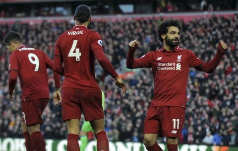 Liverpool's Mohamed Salah, right, celebrates after scoring his side's third goal during the English Premier League soccer match between Liverpool and AFC Bournemouth at Anfield stadium in Liverpool, England, Saturday, Feb. 9, 2019. (AP Photo/Rui Vieira)