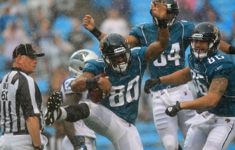 CHARLOTTE, NC - SEPTEMBER 25:  Mike Thomas #80 of the Jacksonville Jaguars celebrates with teammates after a touchdown against the Carolina Panthers during their game at Bank of America Stadium on September 25, 2011 in Charlotte, North Carolina.  (Photo by Streeter Lecka/Getty Images)