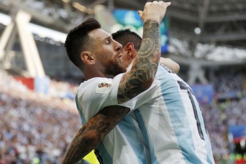 Argentina's Angel Di Maria, right, celebrates with his teammate Lionel Messi after scoring his side's first goal during the round of 16 match between France and Argentina, at the 2018 soccer World Cup at the Kazan Arena in Kazan, Russia, Saturday, June 30, 2018. (AP Photo/Frank Augstein)