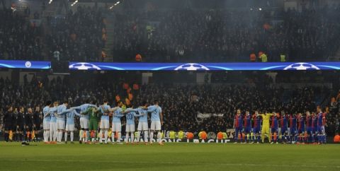 Manchester City, left, and Basel players observe a minute of silence in memory of Fiorentina captain Davide Astori has died in his sleep on Sunday, prior to the start of the Champions League, round of 16, second leg soccer match between Manchester City and Basel at the Etihad Stadium in Manchester, England, Wednesday, March 7, 2018. (AP Photo/Rui Vieira)