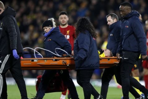 Medics carry Watford's Gerard Deulofeu from the pitch during the English Premier League soccer match between Watford and Liverpool at Vicarage Road stadium, in Watford, England, Saturday, Feb. 29, 2020. (AP Photo/Alastair Grant)