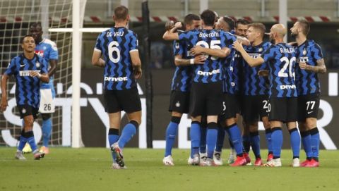Inter Milan's Danilo D'Ambrosio, partially obscured centre, celebrates with his teammatesafter scoring against Napoli during the Serie A soccer match between Inter Milan and Napoli at the San Siro Stadium, in Milan, Italy, Tuesday, July 28, 2020. (AP Photo/Antonio Calanni)