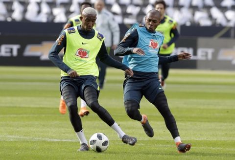 Brazil's Fernandinho, right, and Talisca, left, challenge for the ball during a training session in Berlin, Germany, Monday, March 26, 2018. Brazil will face Germany for an international friendly soccer match on Tuesday, March 27, 2018 in Berlin. (AP Photo/Michael Sohn)