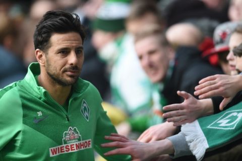 FILE - In this Feb. 27, 2016 file picture, Bremen's Claudio Pizarro  cheers with fans after the German Bundesliga football match between Werder Bremen and SV Darmstadt at the Weserstadion in Bremen, Germany, Werder Bremen striker Claudio Pizarro will miss Saturday's Bundesliga match against Bayern Munich because of a groin injury. Werder said Friday March 11, 2016  that Pizarro will not travel to Munich to face his former team after getting injured in training.  ( Carmen Jaspersen/dpa via AP,file)
